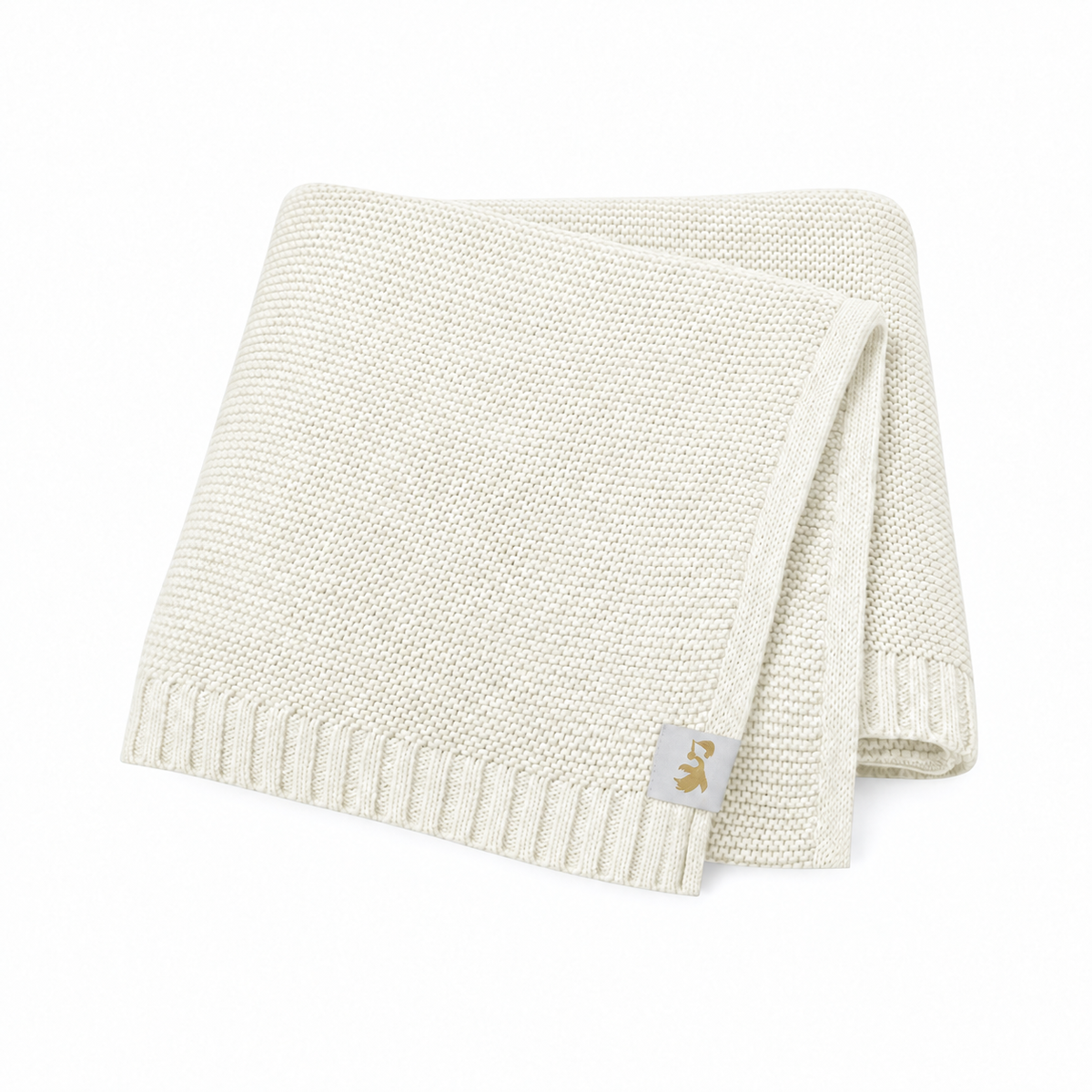 Folded cream knitted baby blanket