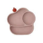 A silicone baby plate in a dusty rose pink color, featuring three compartments and a small red apple-shaped accent on the top left edge, shown against a plain white background.