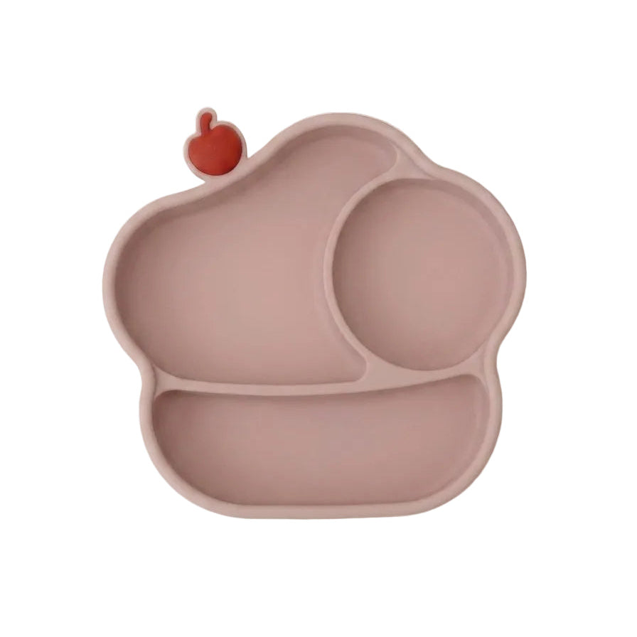 A silicone baby plate in a dusty rose pink color, featuring three compartments and a small red apple-shaped accent on the top left edge, shown against a plain white background.